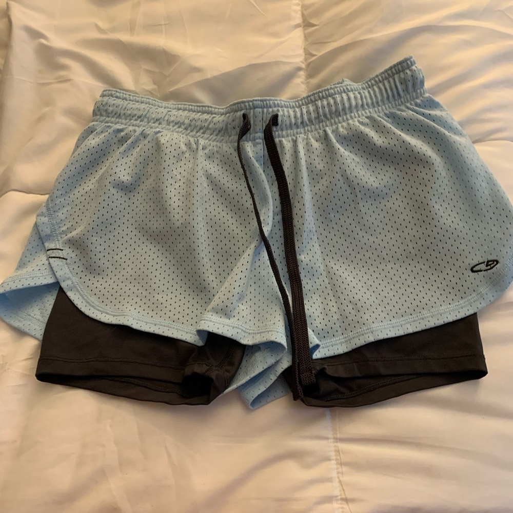 Light blue athletic shorts with grey shorts built in